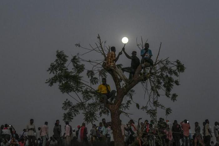 Sudanese protesters keep up a nightime vigil outside the army complex in the capital Khartoum