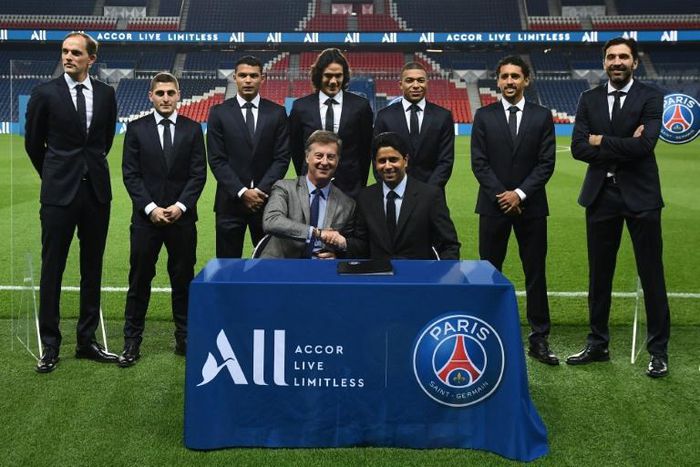 Shake on it: Paris Saint-Germain staff at the signing ceremony
