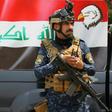 A member of the Iraqi federal police forces stands guard at a checkpoint in Baghdad's Karada district