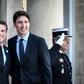 French President Emmanuel Macron (l) welcomes Canadian Prime Minister Justin Trudeau upon his arrival at the Elysee Palace in Paris