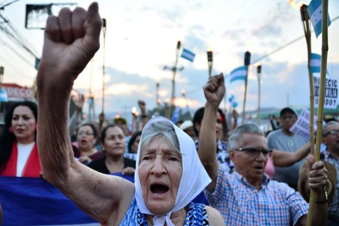 Protestors march to demand the resignation of Honduran President Juan Orlando Hernandez