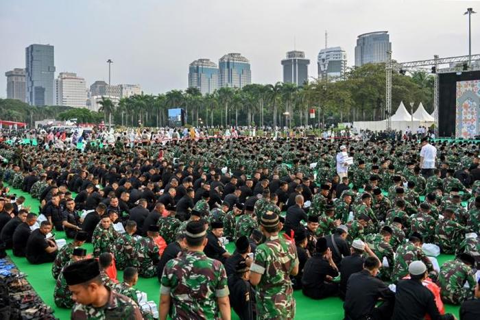 Indonesian police and military personnel gather to break the Ramadan fast with Indonesia's President Joko Widodo in Jakarta on May 16, 2019. Authorities say they have arrested dozens of terror suspects ahead of the forthcoming election result announcem...