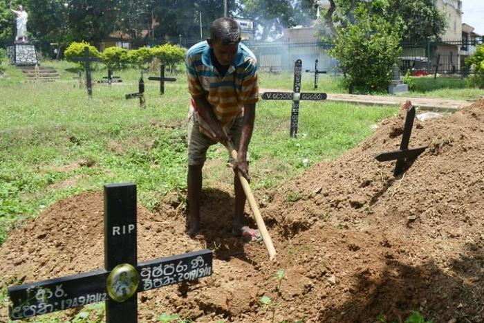 Piyasri Gunasena digs a grave at Madampitiya cemetery in Sri Lanka's capital Colombo -- he usually only digs one a day but since the Easter Sunday attacks, he is far busier
