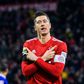 Robert Lewandowski celebrates scoring his 100th goal at the Allianz Arena in Bayern colours