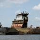Graveyard: Dozens of shipwrecks and abandoned barges litter the Lagos waterways