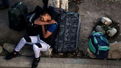 An asylum seeker rests outside El Chaparral port of entry while he waits for his turn to present himself to US border authorities to request asylum, in Tijuana, Mexico, on April 9, 2019