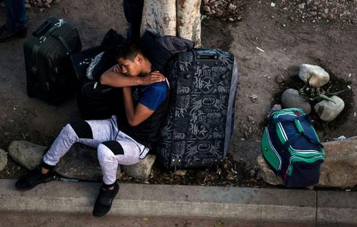 An asylum seeker rests outside El Chaparral port of entry while he waits for his turn to present himself to US border authorities to request asylum, in Tijuana, Mexico, on April 9, 2019