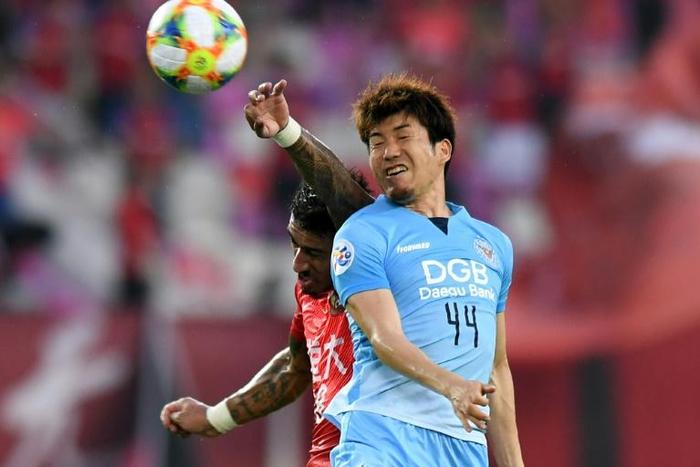 Guangzhou Evergrande's goalscorer Paulinho rises to beat Daegu's Nishi Tsubasa to a header