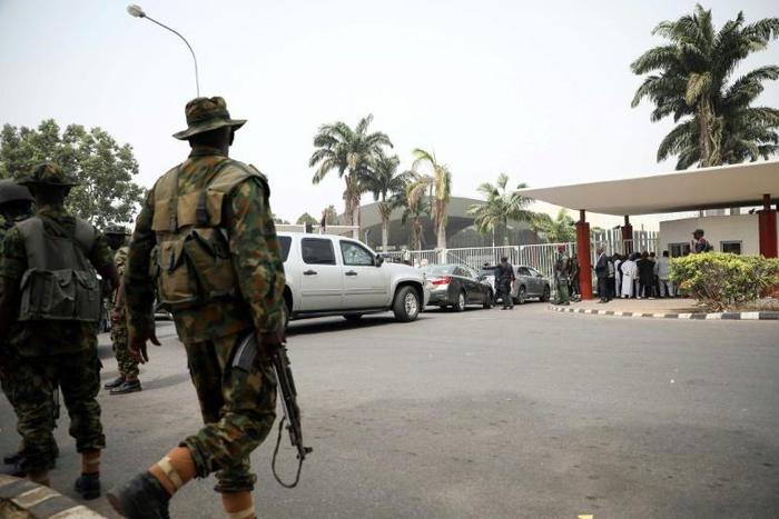 Soldiers pictured outside a meeting in Abuja on February 16 of Nigeria's election board. The electoral body had just announced a week-long postponement of the presidential and legislative elections, hours before voting was due to start
