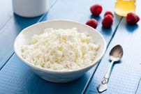Fresh cottage cheese or ricotta or tvorog in a bowl