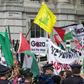 Pro-Palestinian demonstrators carry Palestinian flags and the yellow flag of Lebanese Shiite militant group Hezbollah as they rally outside the gates of Downing Street in London on September 9, 2015