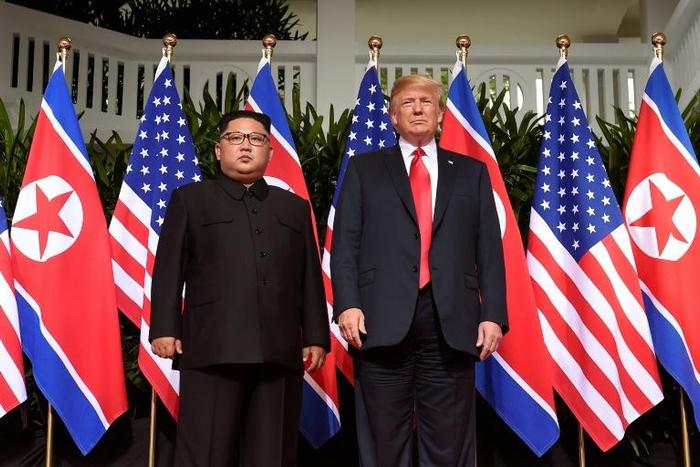 Donald Trump and Kim Jong Un pose for the cameras at their first summit on June 12, 2018 in Singapore