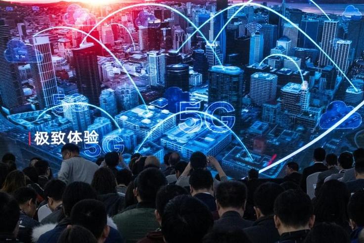 Journalists watch a trailer at the launch of new 5G Huawei products in Beijing in January