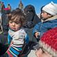 Fully veiled women and children gather after fleeing from the Baghouz area in the eastern Syrian province of Deir Ezzor on February 12, 2019 during an operation by the US-backed Syrian Democratic Forces (SDF) against the Islamic State group