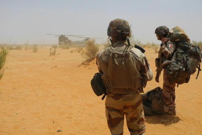Heat and dust: Two French soldiers wait to board a British Chinook helicopter near the new French military base at Gossi, east-central Mali