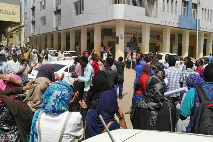 Sudanese protesters take part in an anti-government demonstration in Khartoum, as the government threatened legal action against the movement leaders