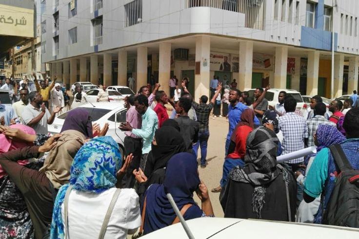 Sudanese protesters take part in an anti-government demonstration in Khartoum, as the government threatened legal action against the movement leaders