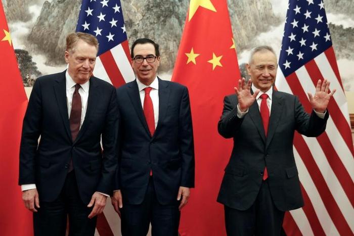 Chinese Vice Premier Liu He (R) gestures as US Treasury Secretary Steven Mnuchin (C) chats with Trade Representative Robert Lighthizer before they go into talks in Beijing