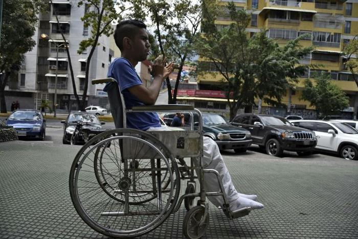 A patient leaves after receiving treatment for kidney failure at a state-run clinic in Caracas, on March 10, 2019