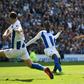 Manchester City's Algerian midfielder Riyad Mahrez (R) scores their third goal during the English Premier League football match between Brighton and Hove Albion and Manchester City at the American Express Community Stadium in Brighton, southern England...