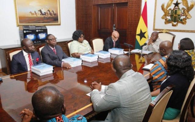 Justice Emile Short presenting the report to Nana Addo