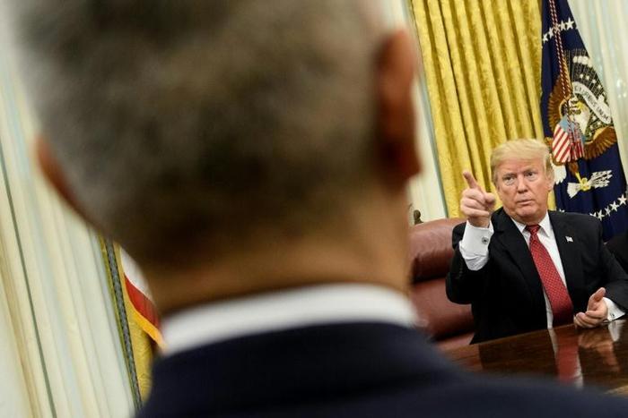 President Donald Trump gestures near Chinese Vice Premier Liu He at the White House on January 31, 2019