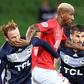 Guangzhou's Anderson Talisca fends off Melbourne Victory's Corey Brown (left) and Terry Antonis