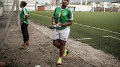 Two members of the FC Mamans national football team, Armelle Sylva and Hairiat Abdourahmane, get ready for their training session