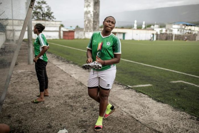 Two members of the FC Mamans national football team, Armelle Sylva and Hairiat Abdourahmane, get ready for their training session