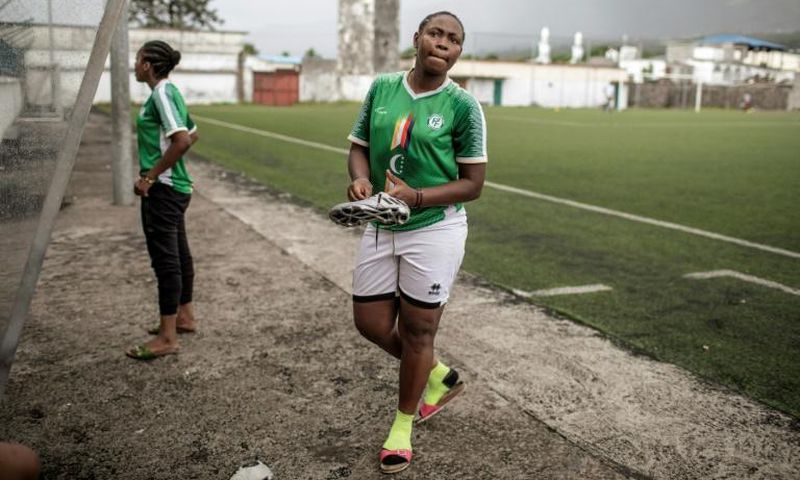 Two members of the FC Mamans national football team, Armelle Sylva and Hairiat Abdourahmane, get ready for their training session