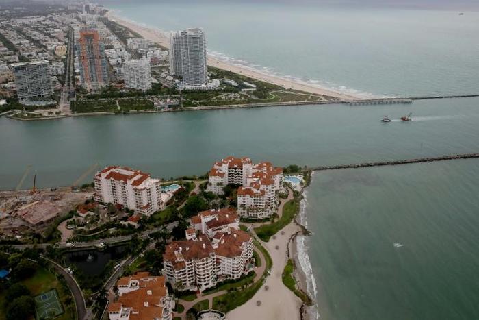 Fisher Island (bottom) in Miami was the home of convicted swindler Anthony Gignac who duped investors by posing as Saudi Prince Khalid Bin Al-Saud