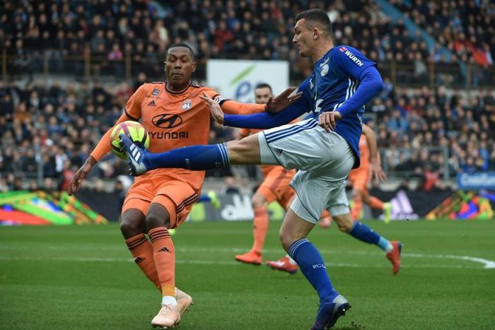 Painful end: Lyon's Brazilian defender Marcelo faces up to Strasbourg forward Ludovic Ajorque on Saturday