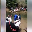 Lady attacks pastor during baptism, drags him into the river(video)