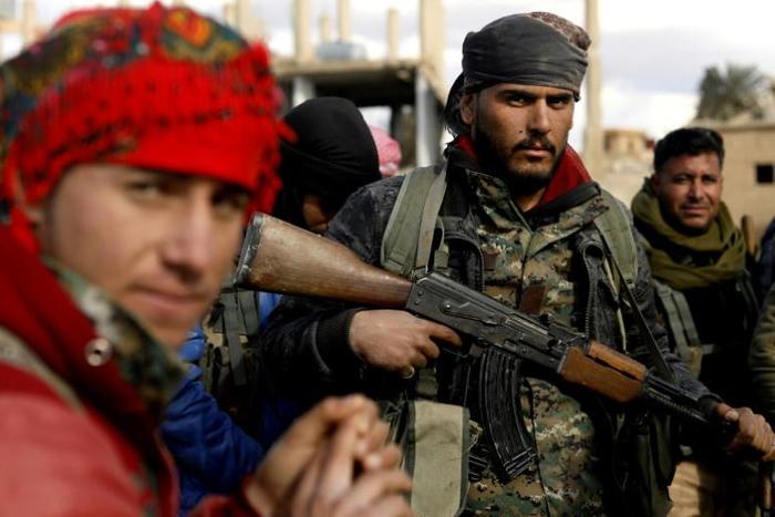 Fighters with the US-backed Syrian Democratic Forces (SDF) in the frontline village of Baghouz where they are fighting against the last shred of the Islamic State (IS) group's "caliphate"