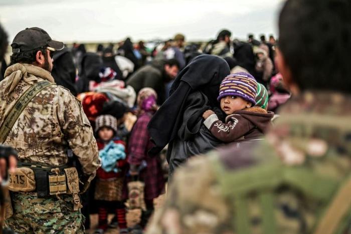 The US-backed Syrian Democratic Forces are evacuating hundreds of people from the ruins of the Islamic State groups's "caliphate" but up to several thousand more remain and commanders want to hold off a final offensive until they too are brought out