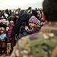The US-backed Syrian Democratic Forces are evacuating hundreds of people from the ruins of the Islamic State groups's "caliphate" but up to several thousand more remain and commanders want to hold off a final offensive until they too are brought out