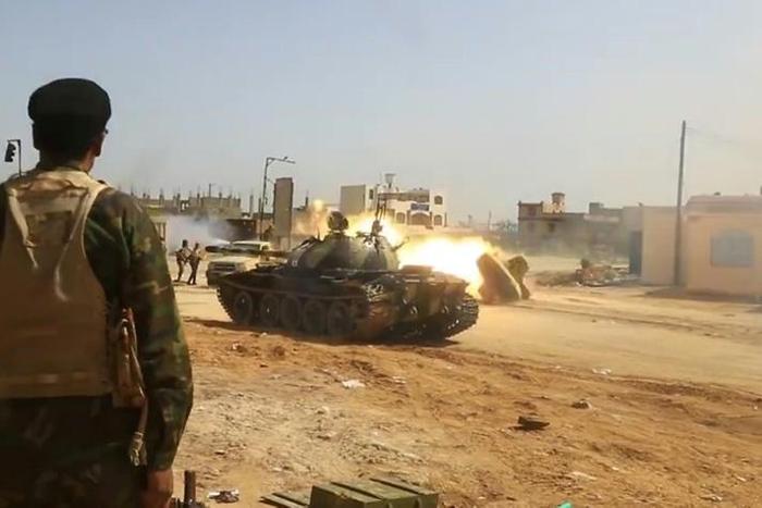 Image from a video published on the Libyan strongman Khalifa Haftar's self-proclaimed Libyan National Army War Information Division's Facebook page on April 16, 2019, shows a tank firing its turret reportedly in a southern suburb of the capital Tripoli...