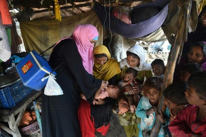 A Pakistani health worker administers drops to a child during a polio vaccination campaign in Lahore