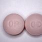 This undated handout file photo obtained courtesy of the US Drug Enforcement Administration shows 20 mg pills of the opioid painkiller OxyContin