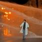 A Moroccan teacher walks through a water cannon during a demonstration calling for permanent contracts