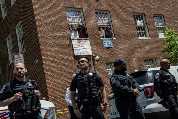 Pro-Nicolas Maduro supporters and activists occupying the Venezuelan embassy in Washington waved earlier this week from a window to Reverend Jesse Jackson (unseen) who came to support them. The opposition said Thursday the building had been cleared by ...