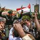 A Sudanese soldier joins protesters outside the army complex in Khartoum