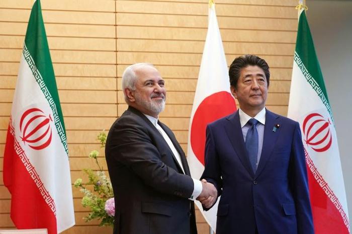 Iranian Foreign Minister Mohammad Javad Zarif (L), seen here with Japan's PM Shinzo Abe, is set to visit China Friday for talks on "regional and international issues," state news agency IRNA reports