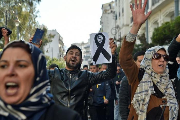 Young demonstrators take part in a protest against President Abdelaziz Bouteflika's candidacy for a fifth term in Algiers