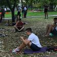 People look at their smartphones in central Moscow in August 2016 -- dating app Tinder has now been required to register with Russian security services