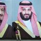 A Pakistani man waits for transport in front of billboards showing portraits of Saudi Arabian Crown Prince Mohammed bin Salman and his father, King Salman bin Abdulaziz, ahead of the Salman's state visit from February 16 - 17