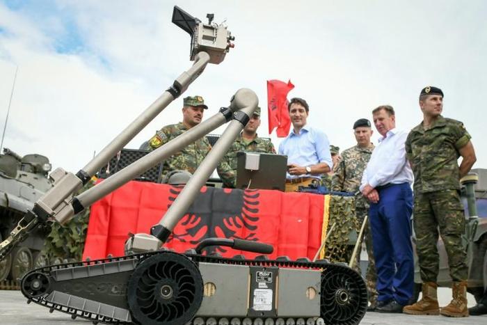 Canadian Prime Minister Justin Trudeau observes a military robot as he meets with Latvian, Canadian and other NATO soldiers in Adazi, Latvia, in July 2018