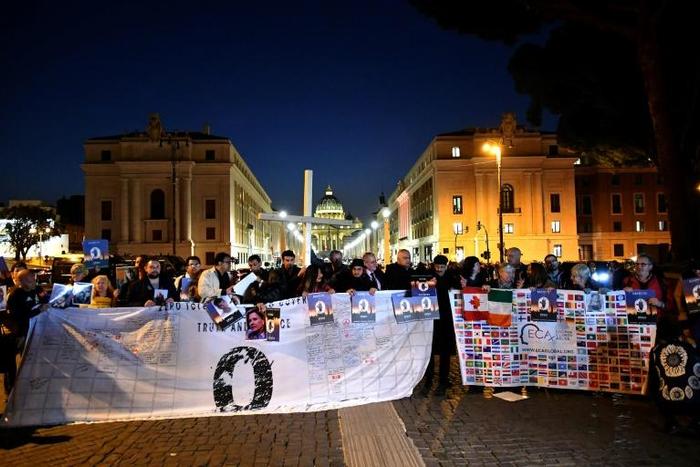 Members of Ending Clergy Abuse, a global organization of prominent survivors and activists who are in Rome for the papal summit on the sex abuse crisis within the Catholic Church, hold a cross during a protest by the Castel Sant'Angelo in Rome