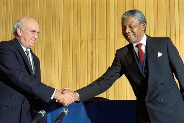 Nelson Mandela became the country's first black president taking over from FW de Klerk (L)