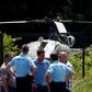 A picture taken on July 1, 2018, north of Paris shows police near a French helicopter Alouette II abandoned by French armed robber Redoine Faid after his escape from prison in Reau.